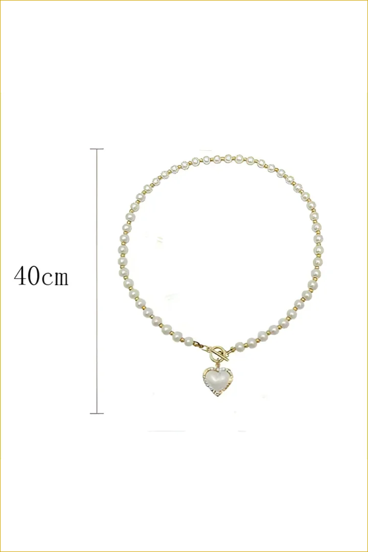 Pearl necklace with heart pendant.