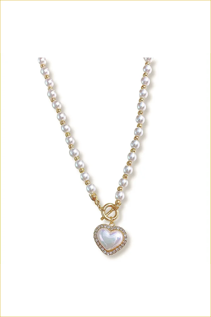 Pearl and gold bead necklace with heart pendant.